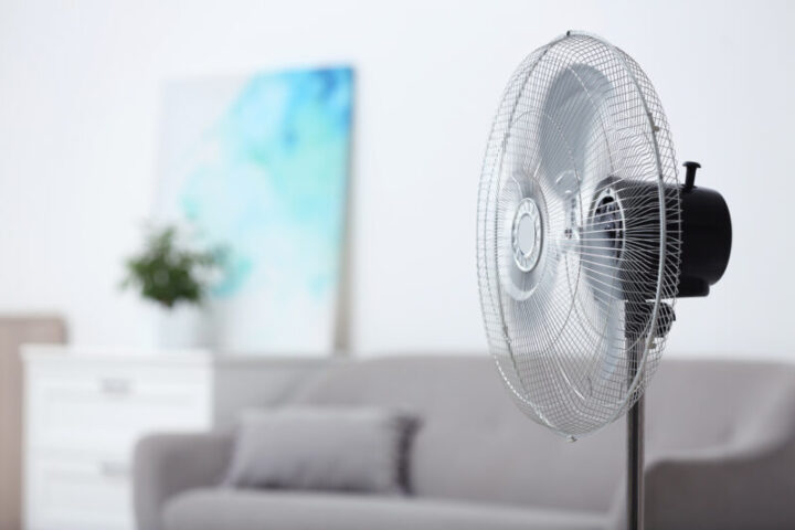 Modern electric fan in room. Space for text